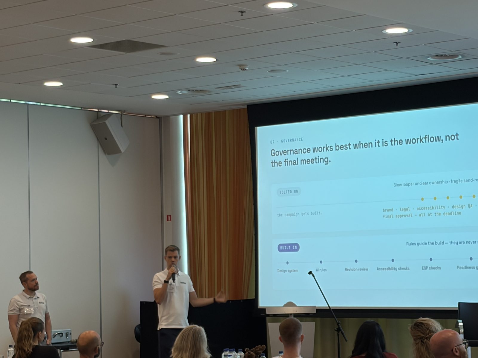 Simon presenting the slide "Governance works best when it is the workflow, not the final meeting." in Amsterdam